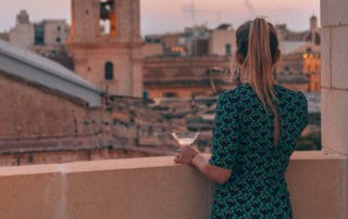girl looking out over Valletta at U collection apartment