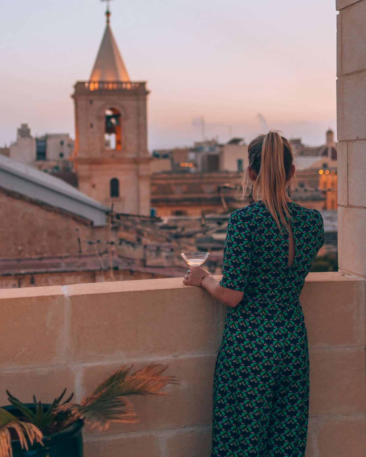 girl looking out over Valletta at U collection apartment