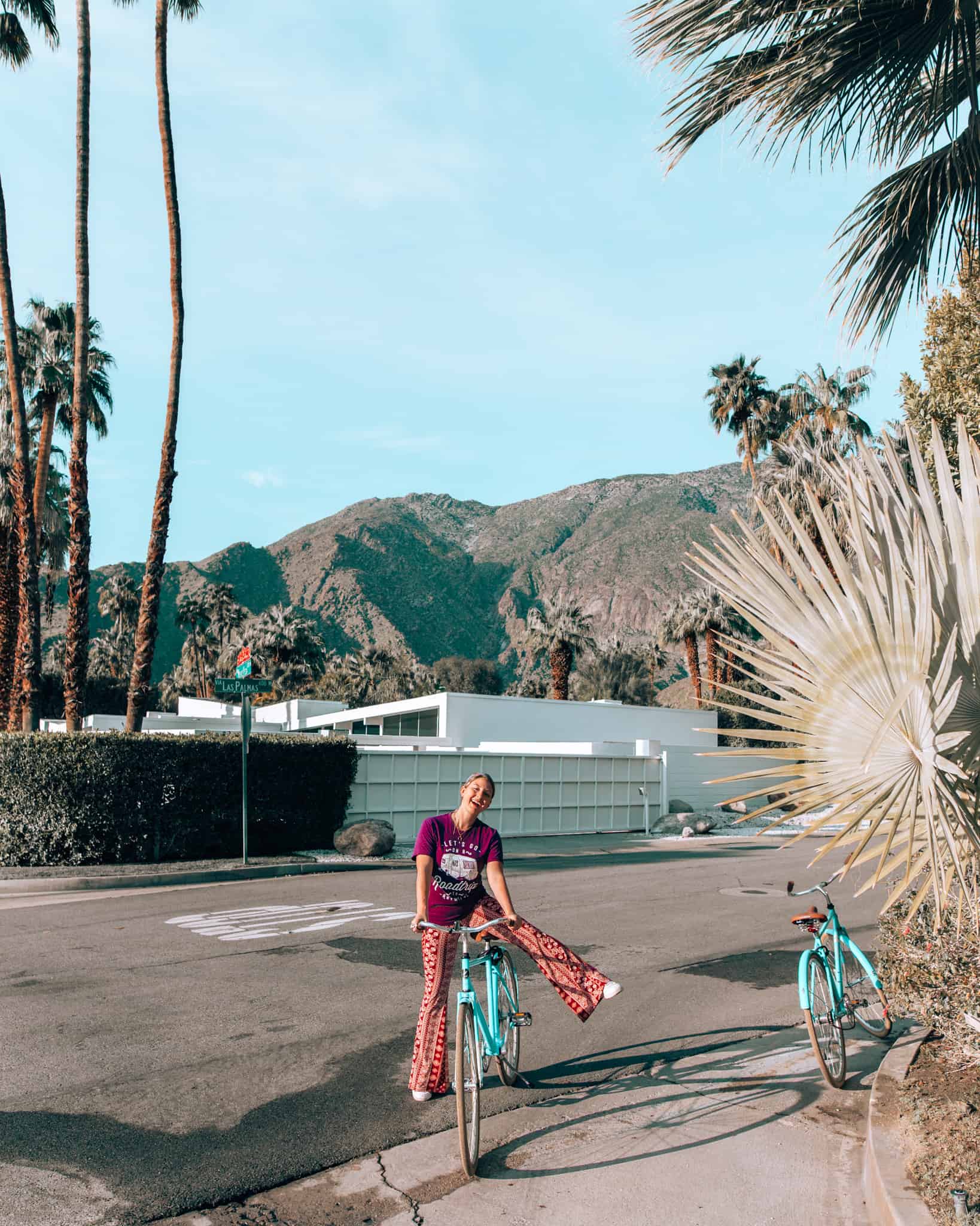 girl putting leg over bike