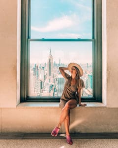 Sitting in window at top of the rock NYC, one of the best Instagram spots in NYC