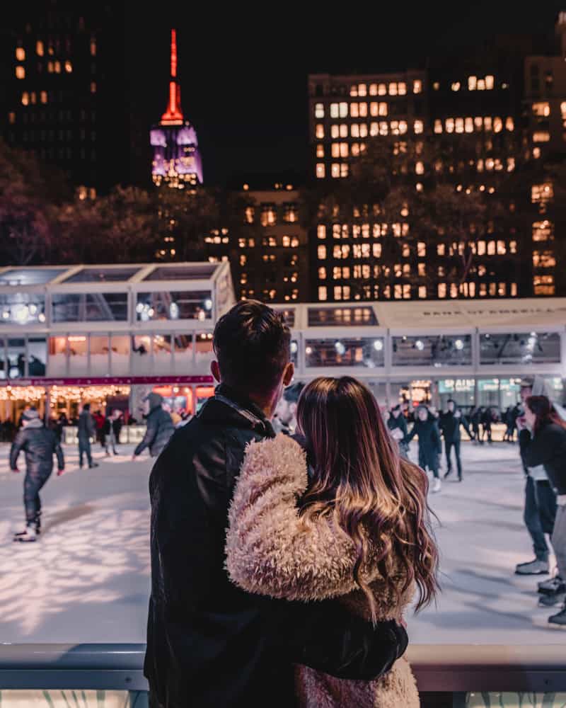 couple standing in front of ice skating rink
