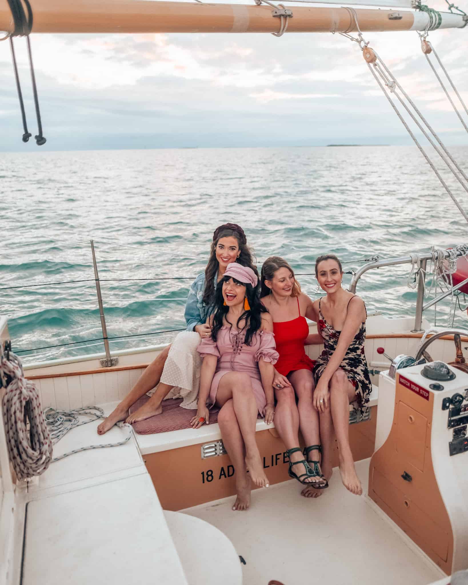girls on a sail boat at sunset