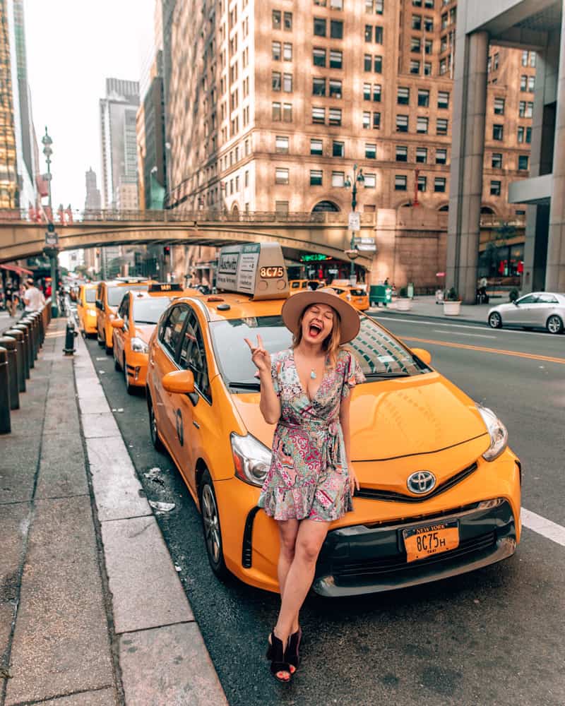 girl sitting on yellow cab