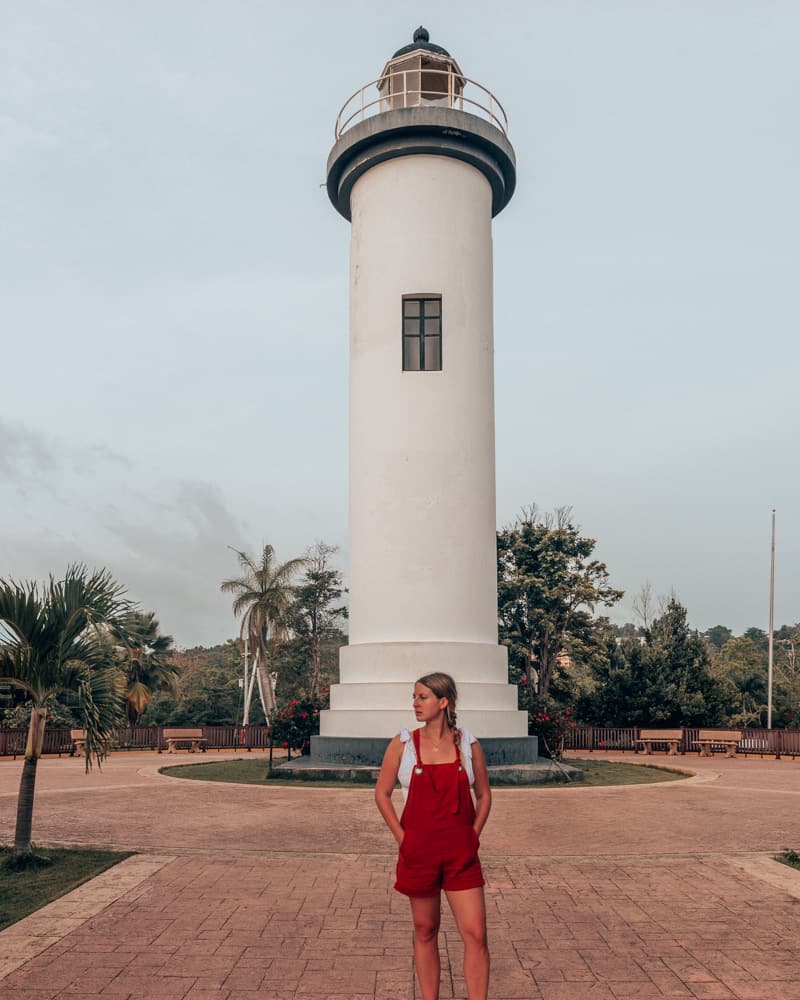 girl standing in front of lighhouse