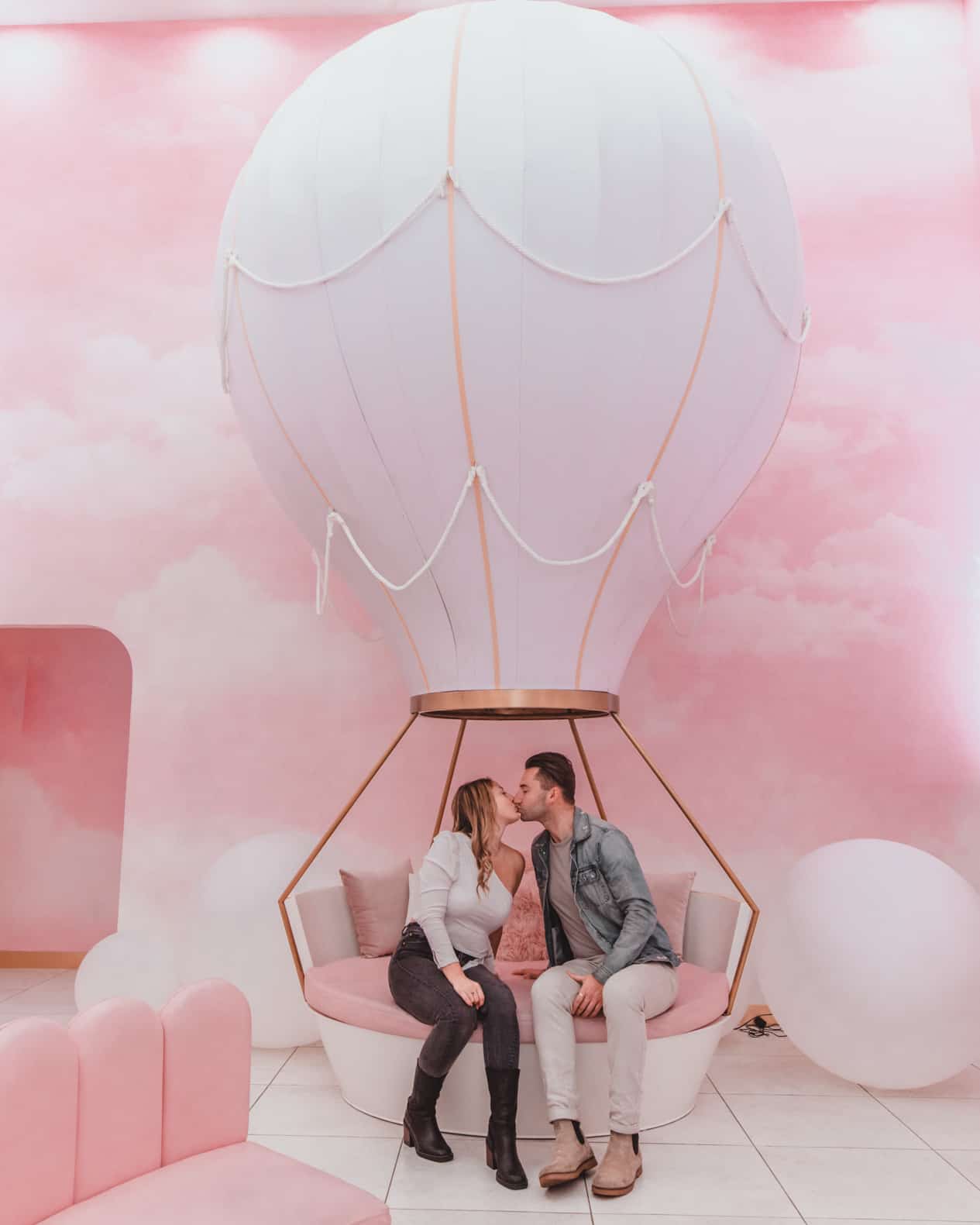 couple sitting in pink cafe