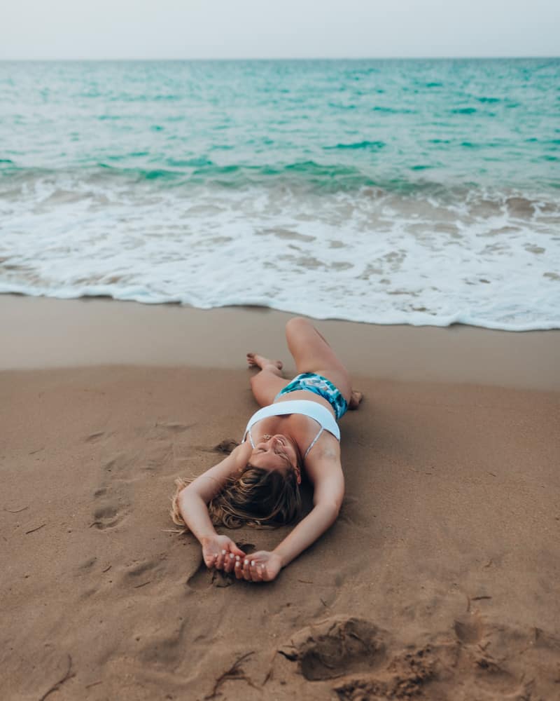 girl laying on beach