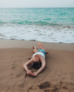 girl lying on the beach in San Juan