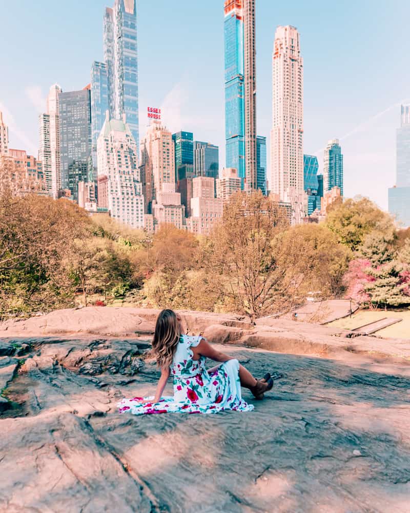sitting on a rock in Central Park one of the best Instagram spots in NYC