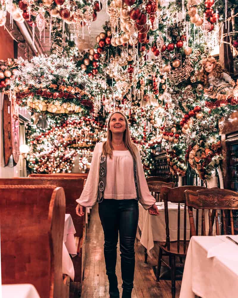 girl standing in restaurant with Christmas decor