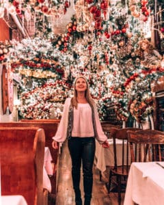 girl standing in restaurant with Christmas decorations