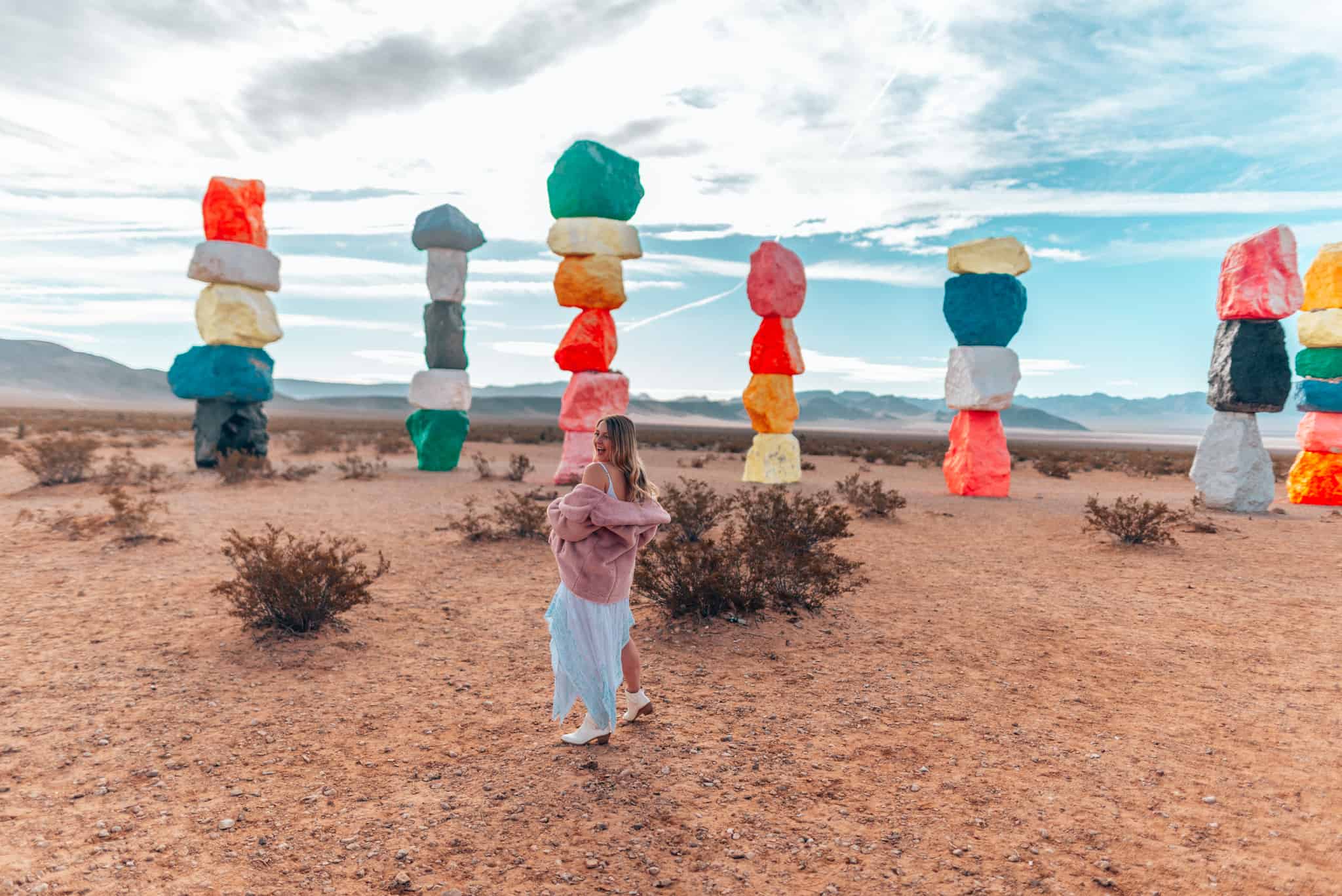 girl standing in front of Seven magic Mountains 