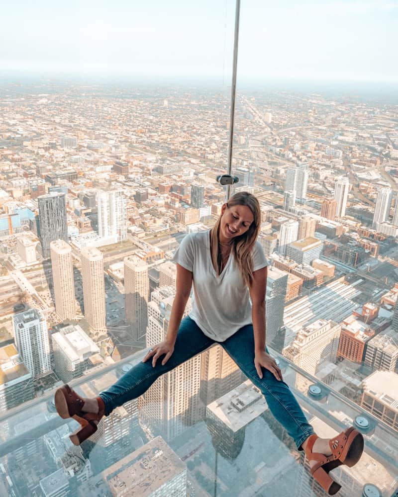 girl sitting in window at Sky Deck
