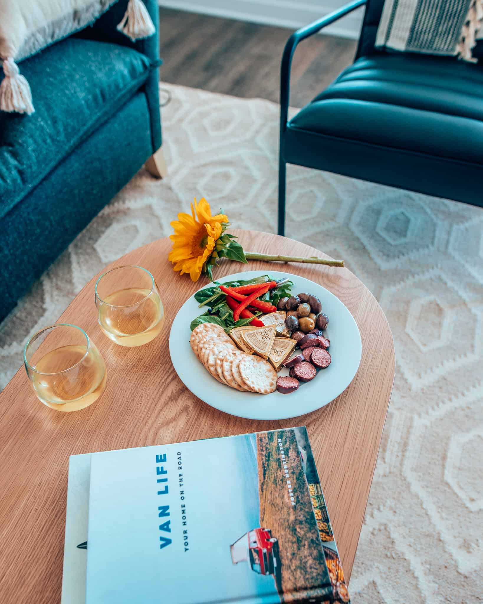 wine and snacks on wooden coffee table at Sonder Apartment
