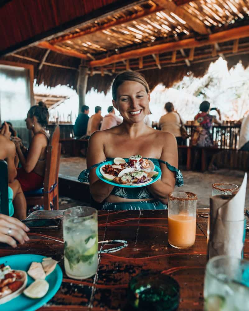 girl holding tacos