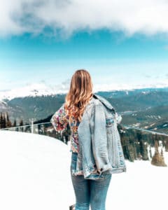girl standing at whistler peak